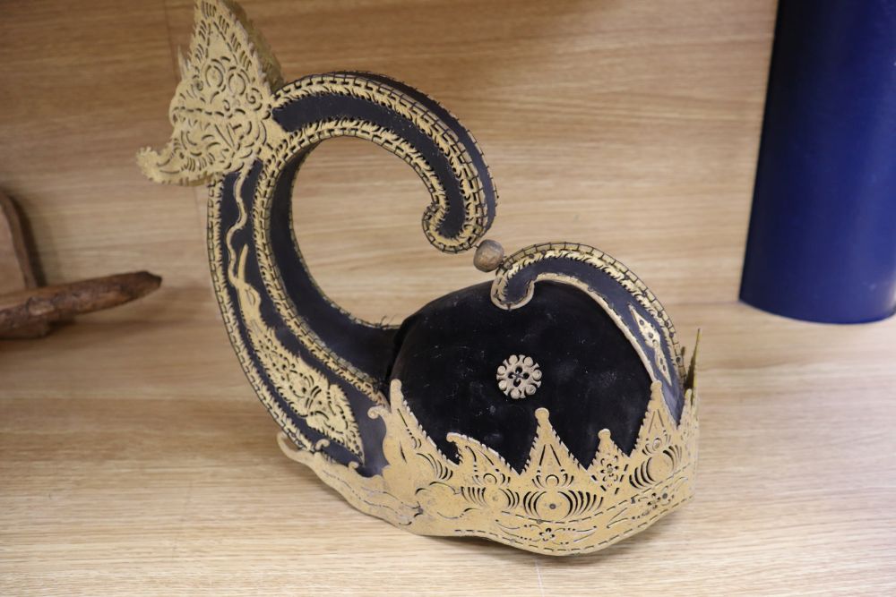 A 19th century Javanese kris, with 14 inch blade, two other edged weapons and a ceremonial head-dress